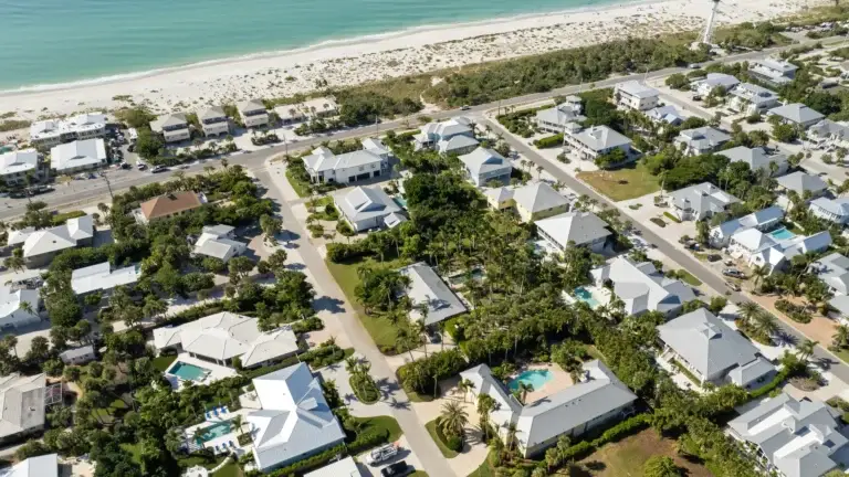 Aerial view of luxury waterfront homes near a beach