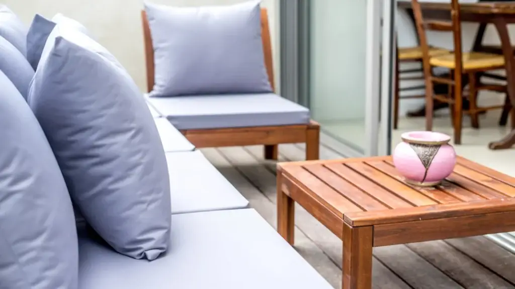 White sofa with cushions beside a wooden coffee table